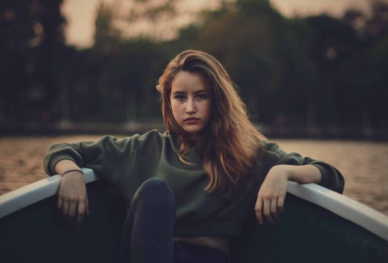 serious woman sitting on fishing boat