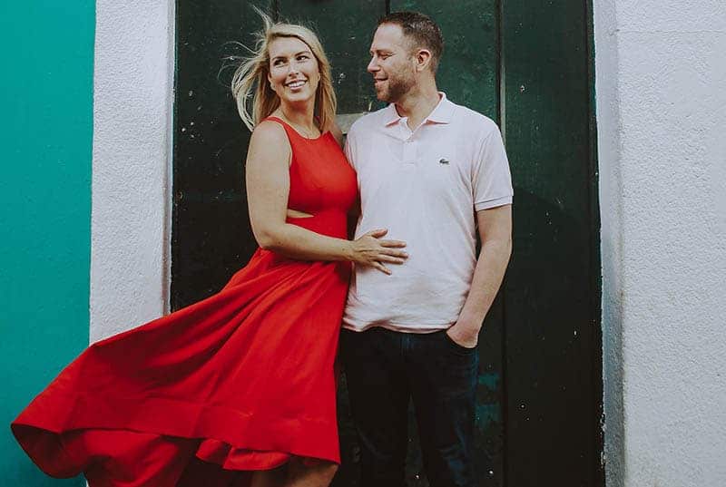 man hugging woman in red dress