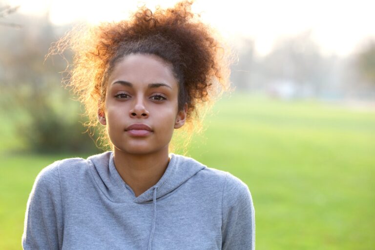 beautiful woman with curly hair in park