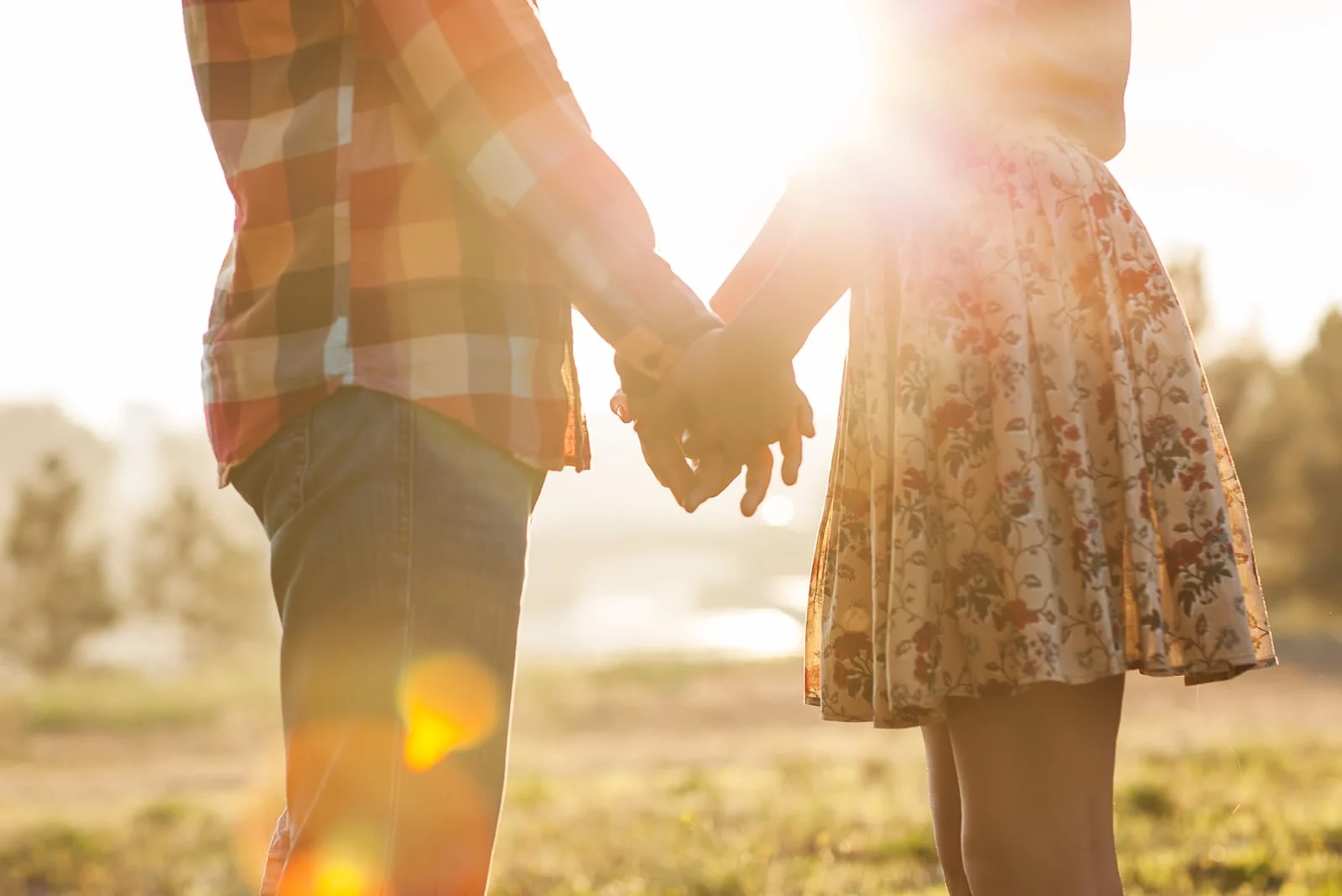 a man and a woman standing holding hands