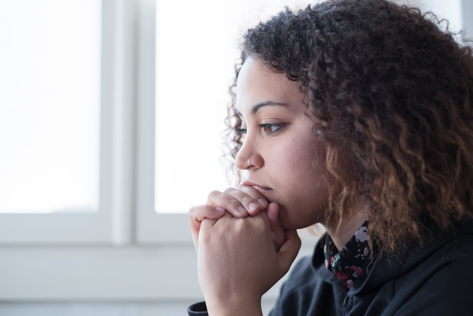 a portrait of a sad worried black woman