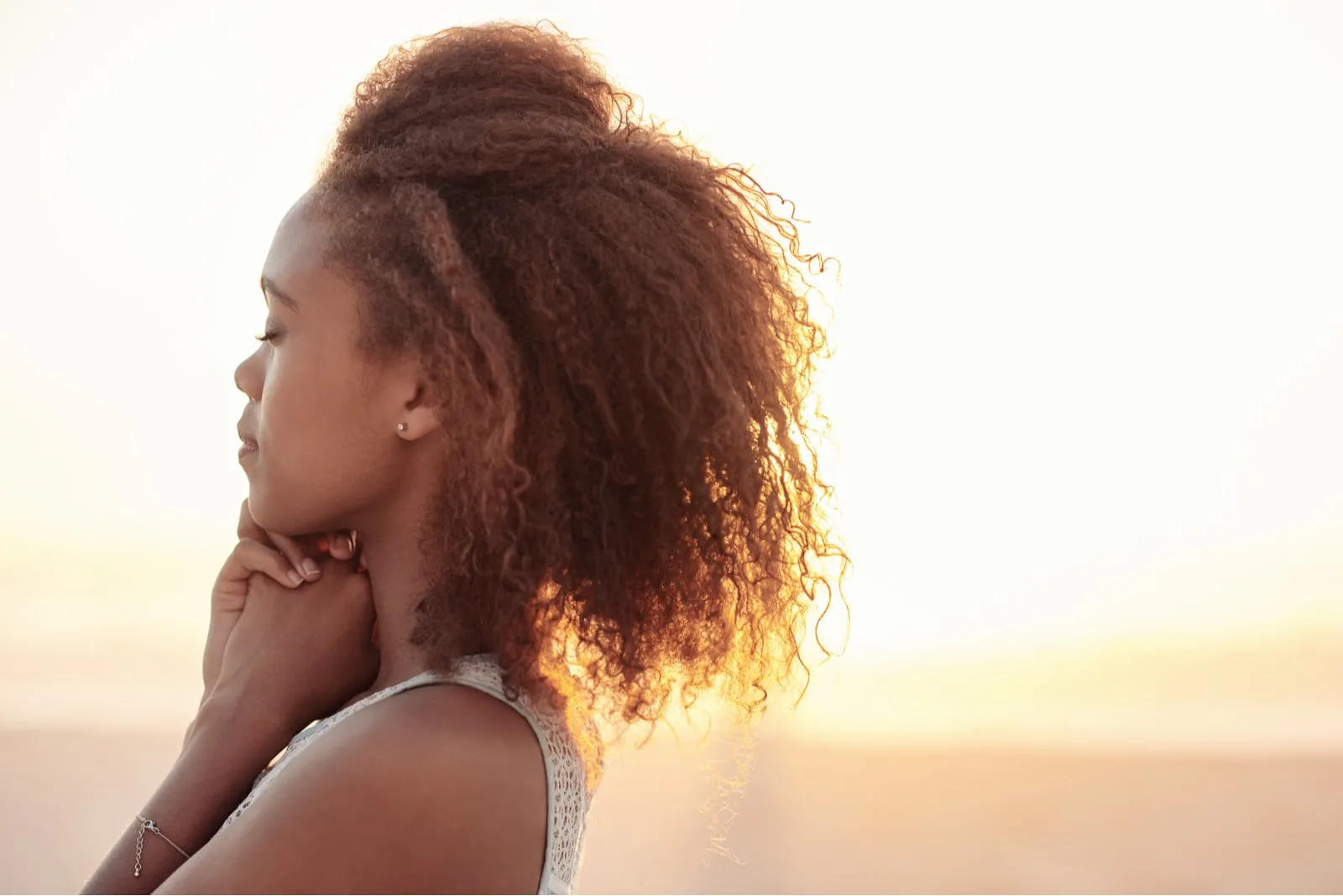 a young black woman enjoys the sunset