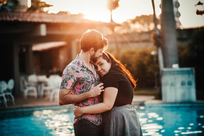 couple hugging at pool