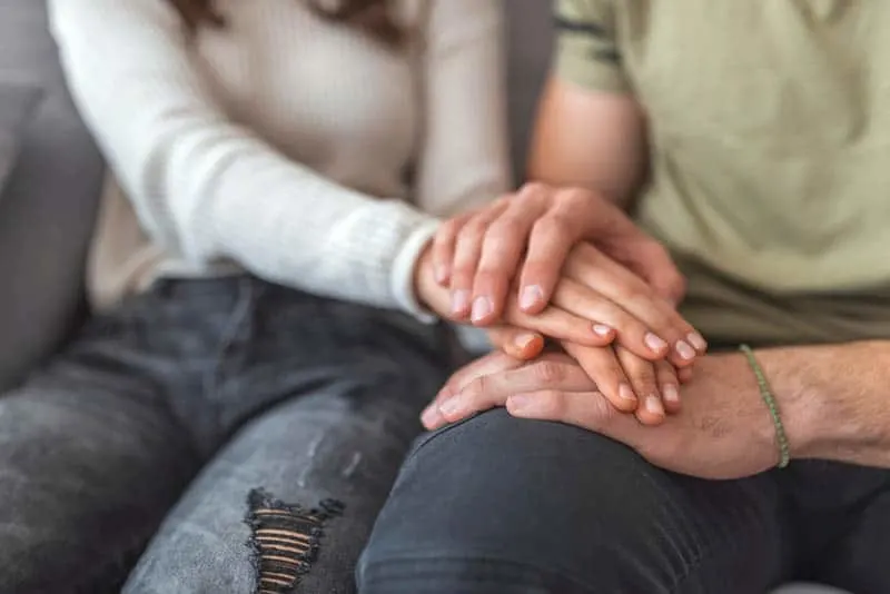 couple sitting and holding hands
