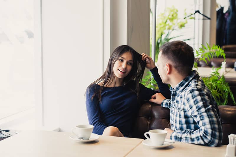 happy couple talking at cafe