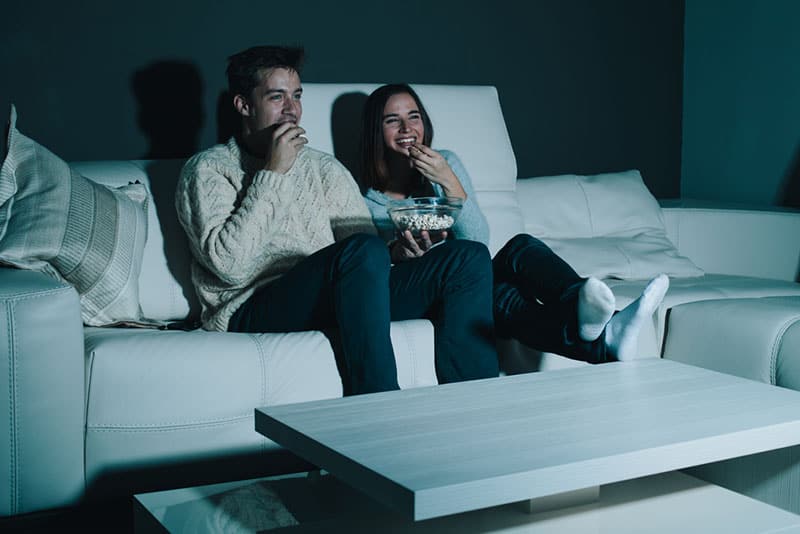 happy couple watching a movie