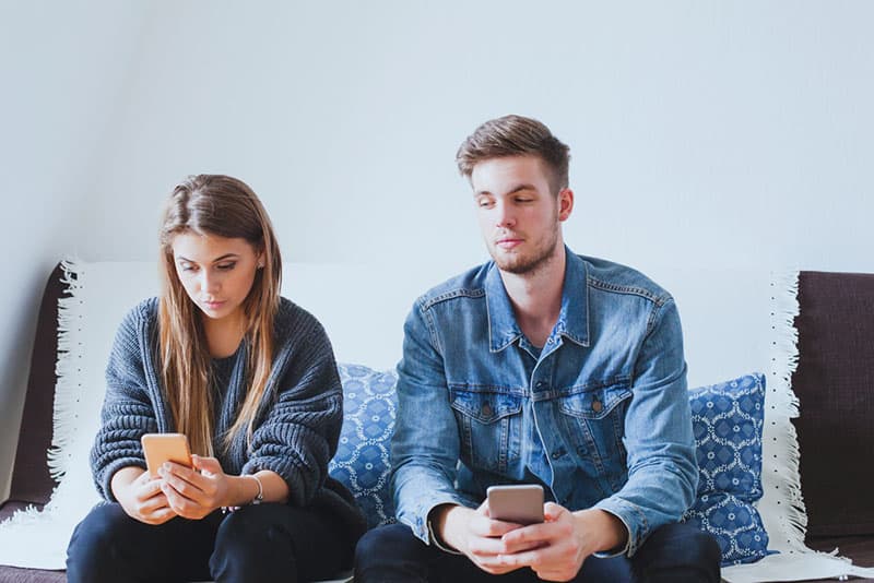 jealous man looking at womans phone