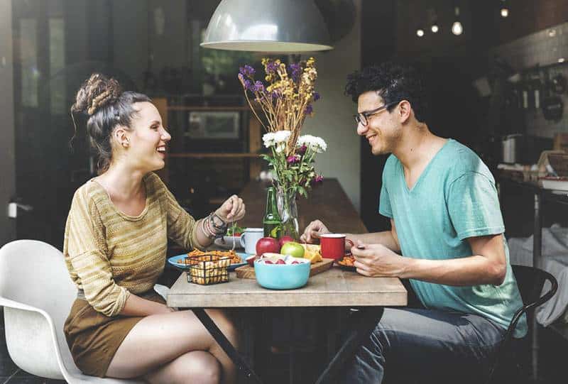 man and woman eating at restaurant