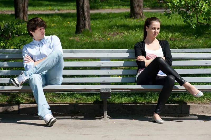 man looking at woman on the bench