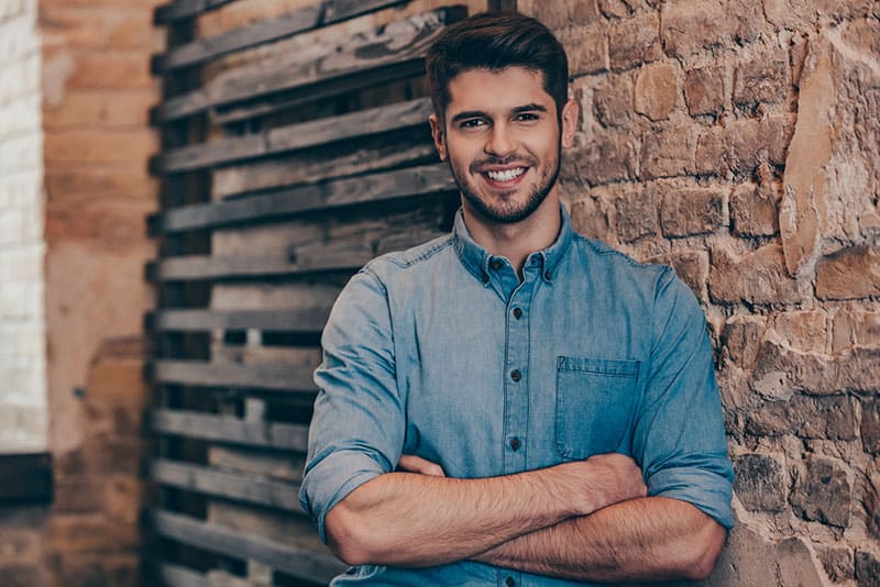 smiling and handsome man looking at camera