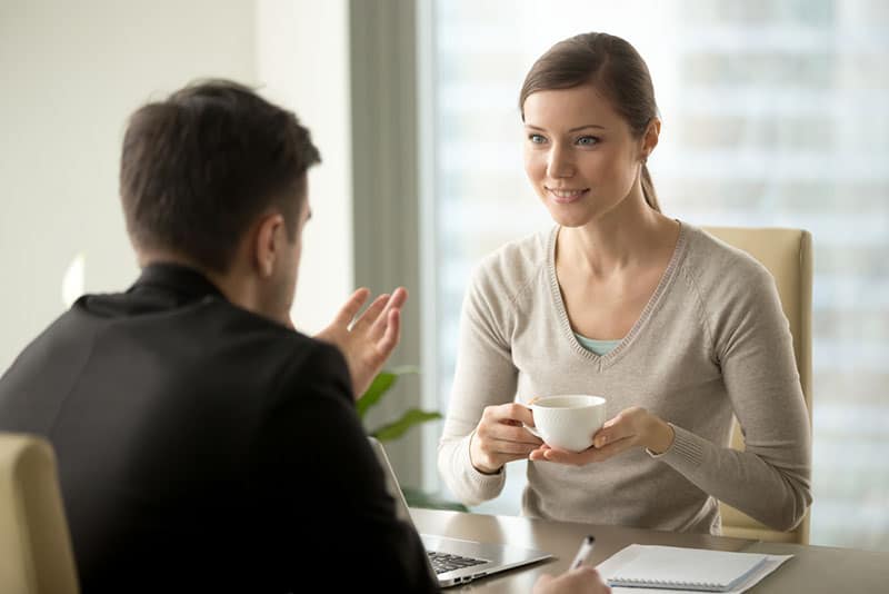 smiling woman listening to man