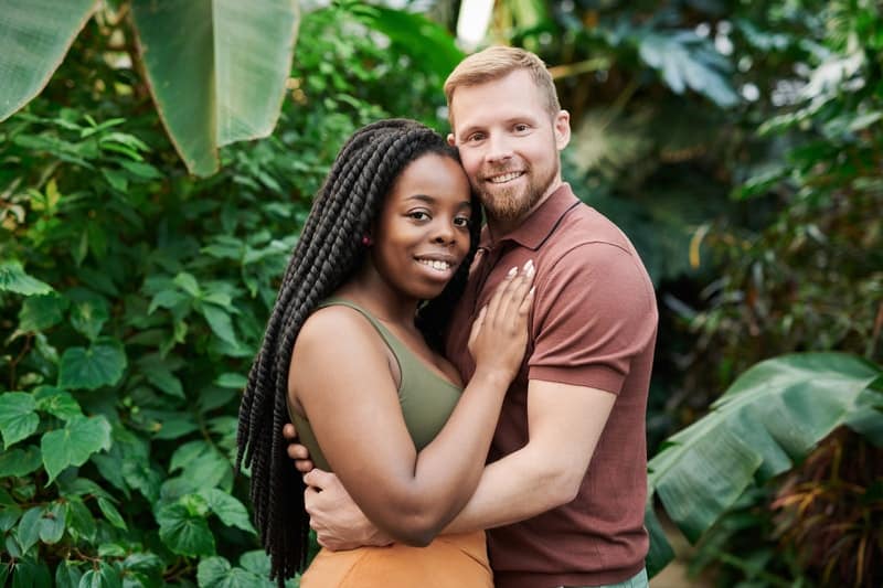 white man hugging black woman