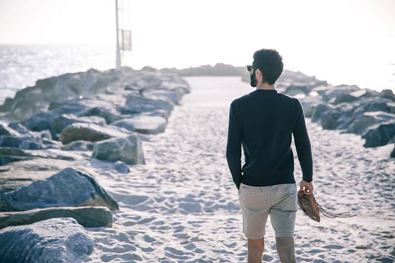 young man walking to the sea