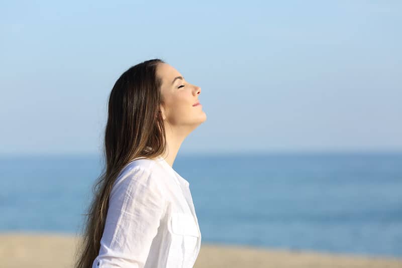 young woman breathing fresh air