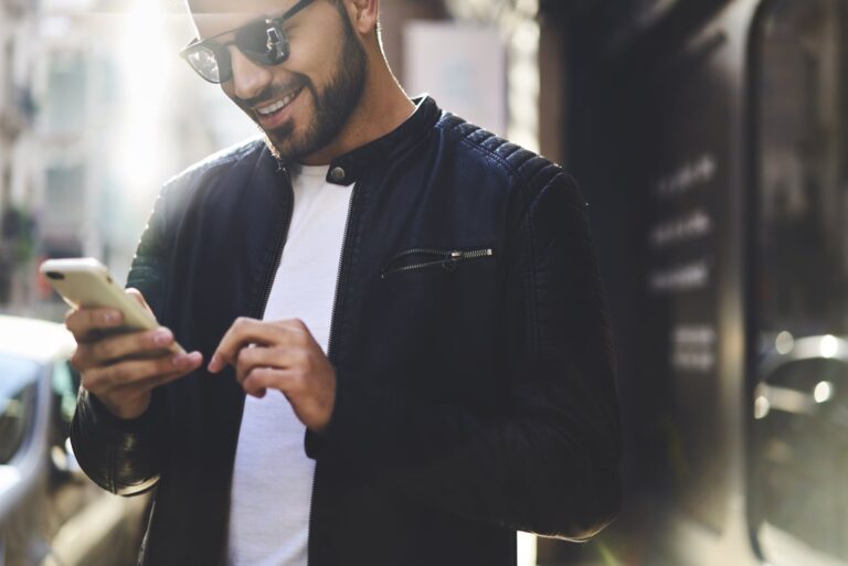 handsome trendy guy looking at his cellphone