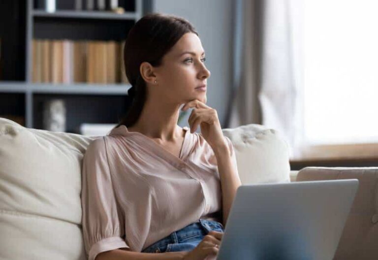 thoughtful woman sitting at home