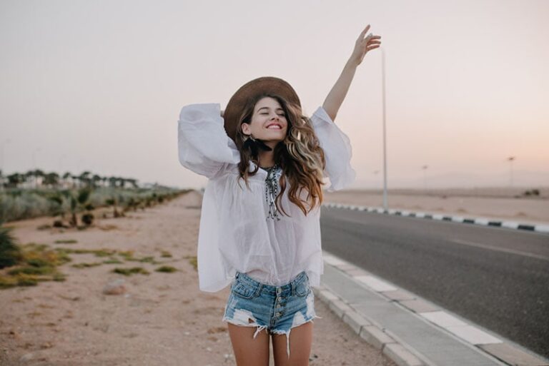 happy woman standing on the road
