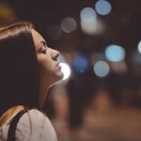 side view of sad woman outside during night