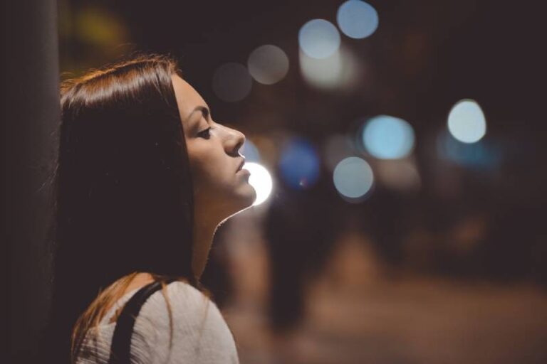 side view of sad woman outside during night