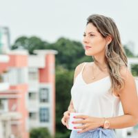 woman standing outdoors and looking away with pensive look