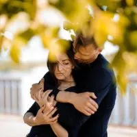 man hugging sad woman outdoor