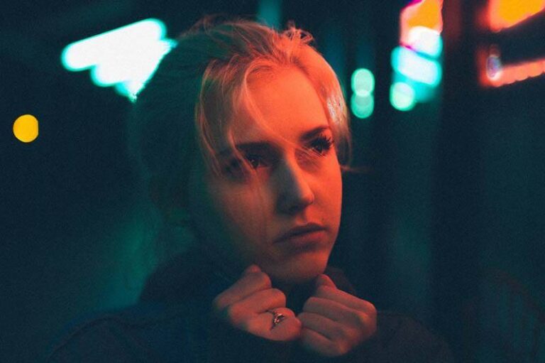 sad blonde woman during night