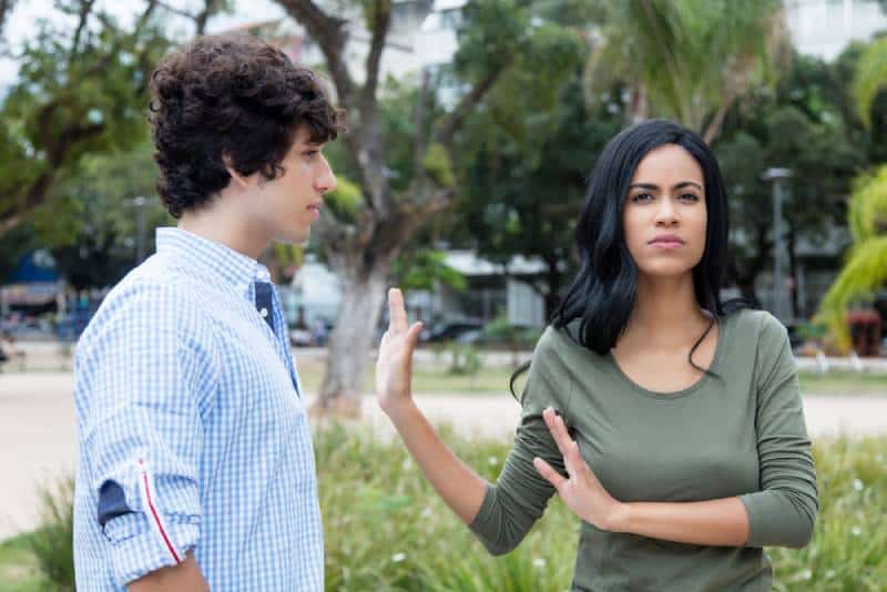 Latin American woman rejecting man outdoors in city
