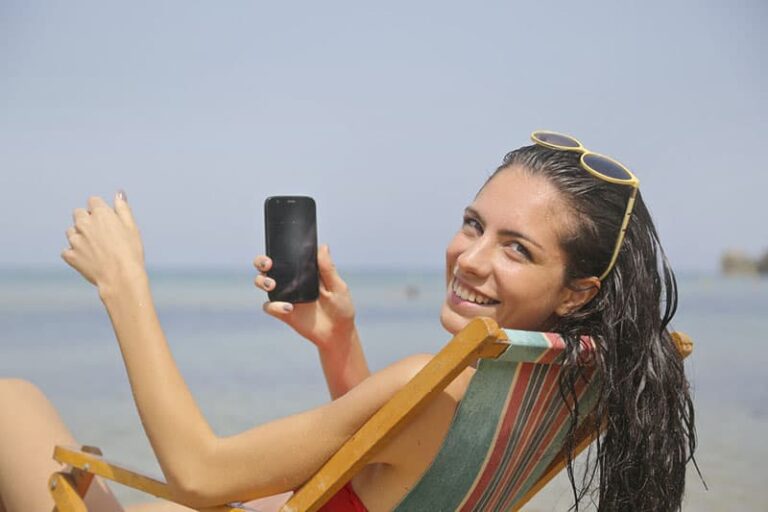 attractive woman sitting on beach chair