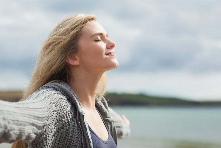blond woman enjoying fresh air