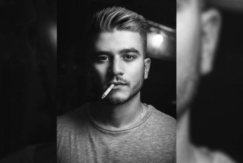 black and white photo of man smoking cigarette