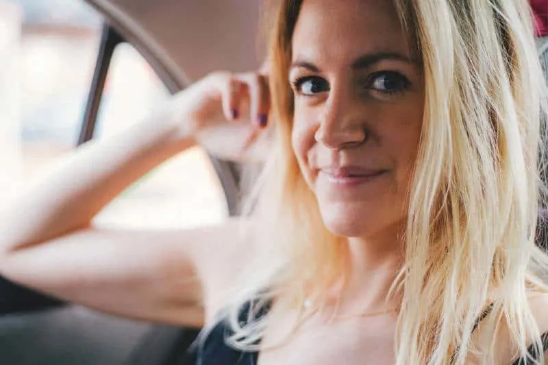 blonde woman smiling in the car