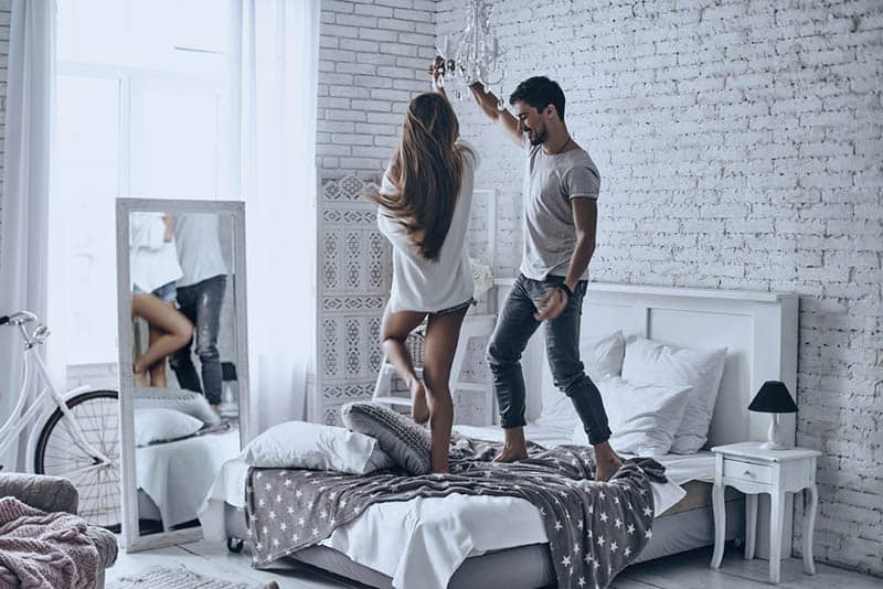 couple dancing on bed