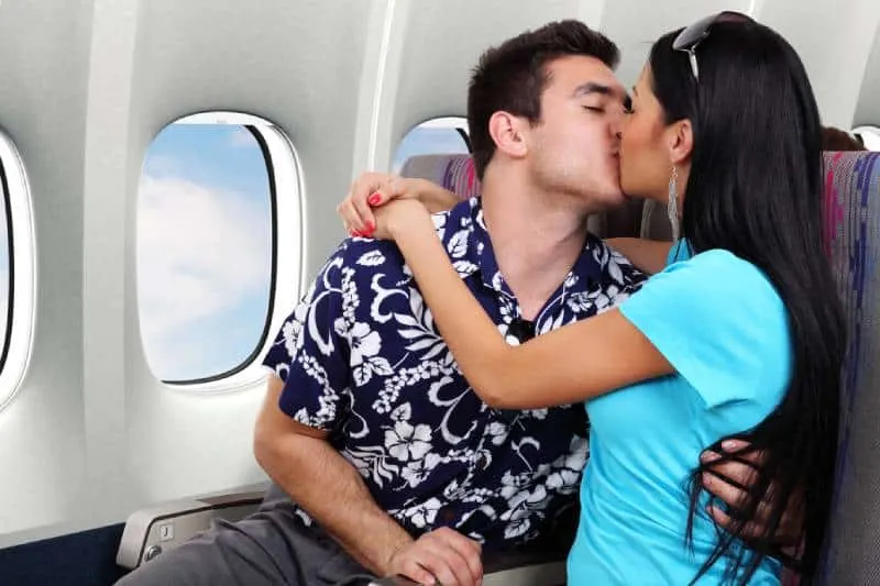 couple kissing in airplane