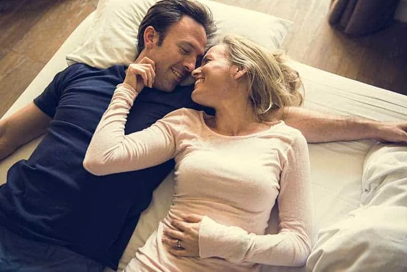 couple laying on floor and looking each other