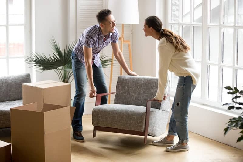 couple replacing chair at home