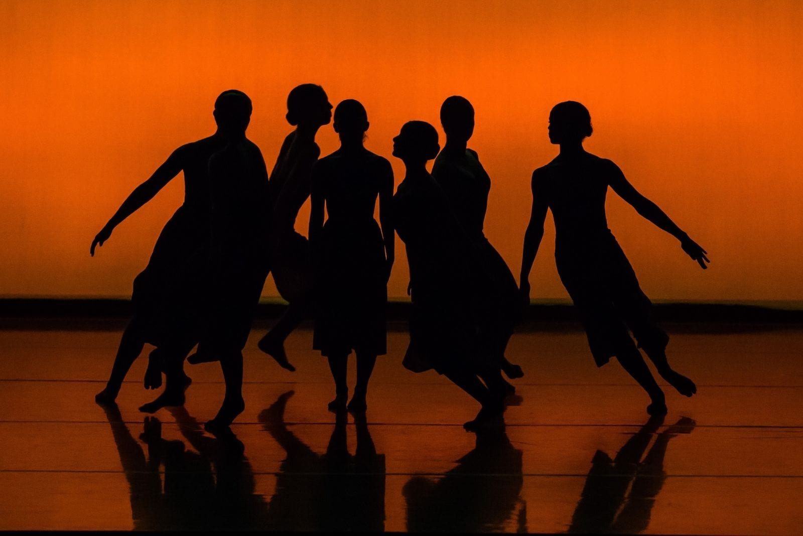 silhouette of a group of dancing women