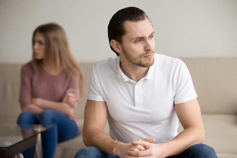 thoughtful man sitting in front of woman