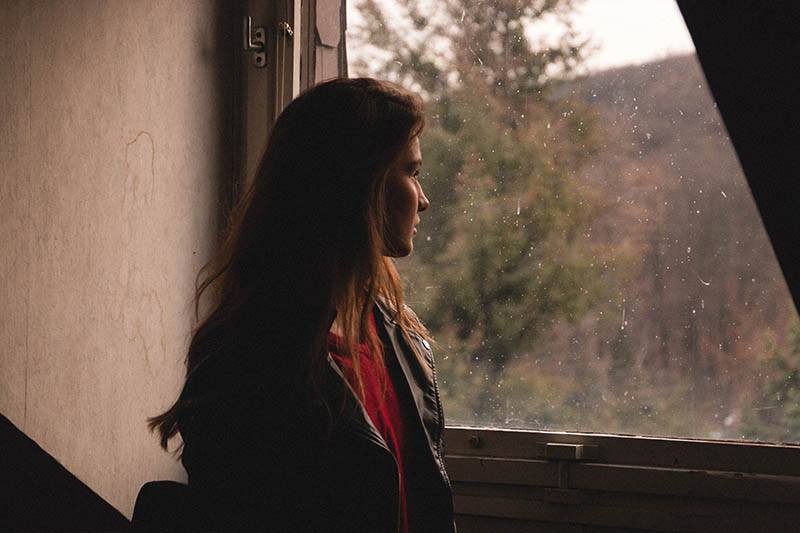 woman looking outside at home