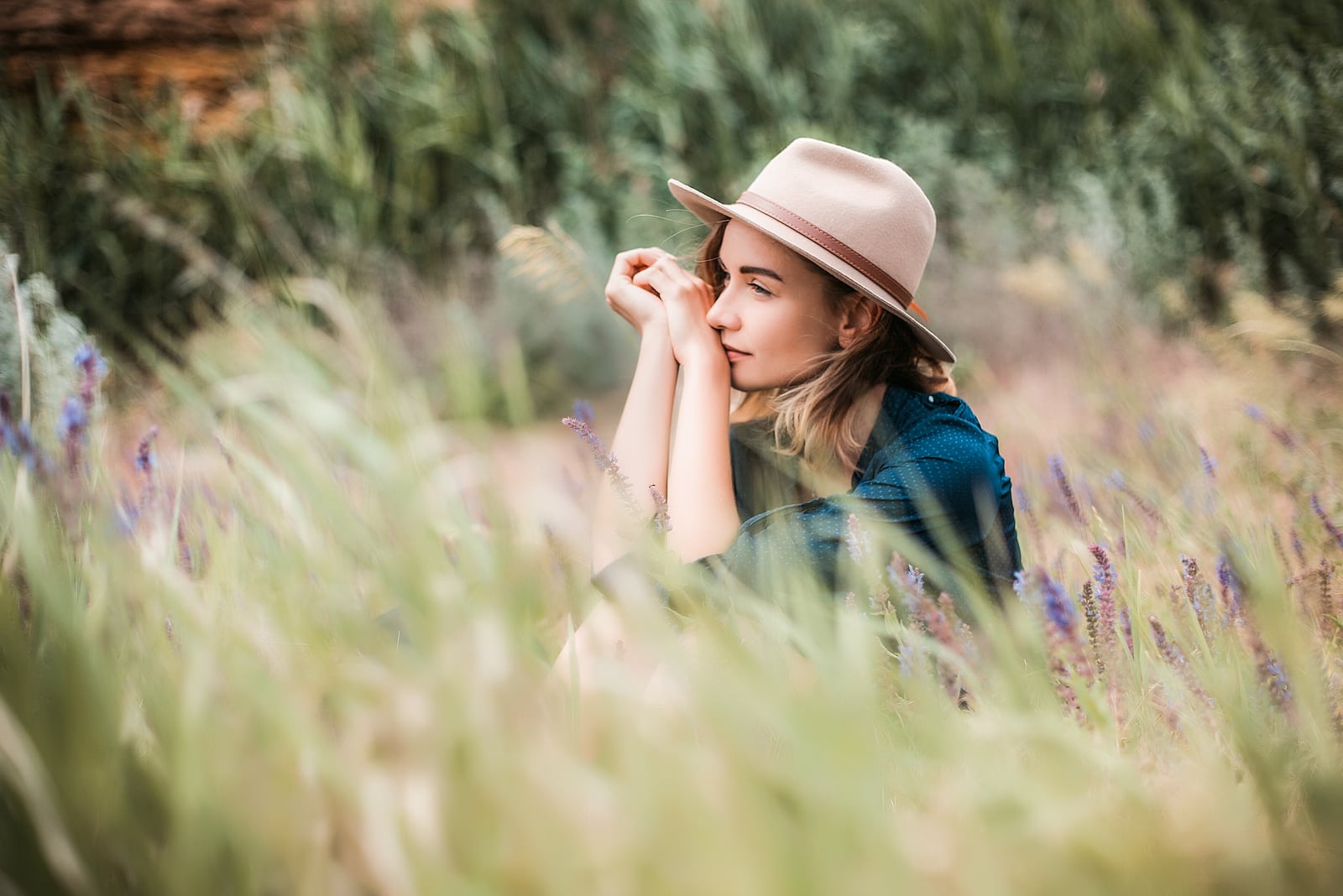 woman sitting in a grass on sunny day