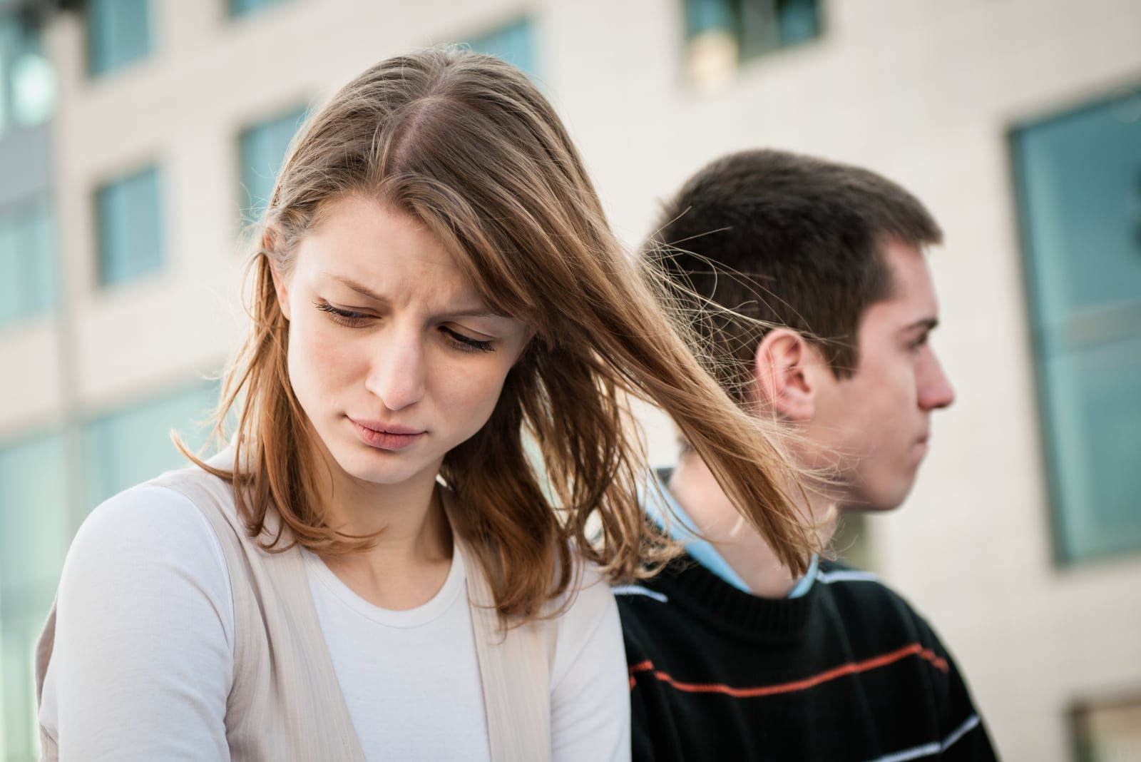 young woman and man outdoor on street having relationship problems