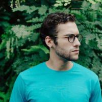 man wearing blue t-shirt and eyeglasses