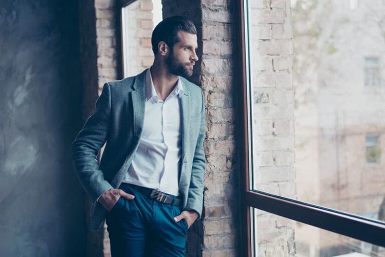 man in suit standing by the window