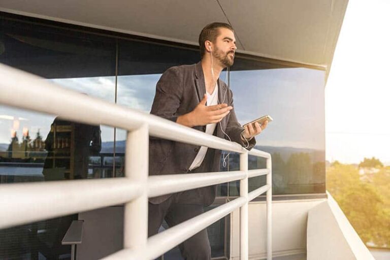 man talking on his phone on balcony