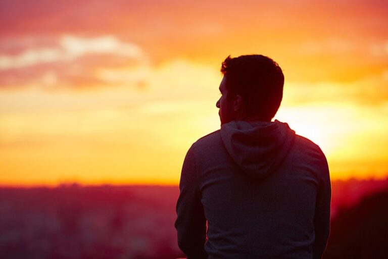 lonely man watching the sunset