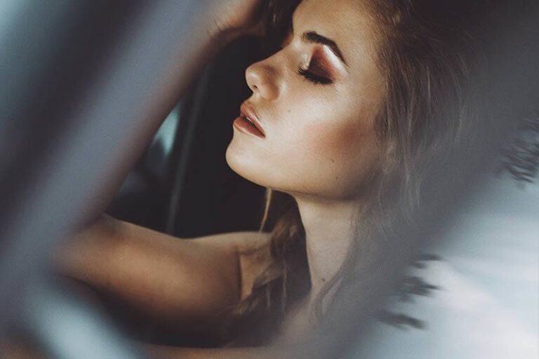 the brunette is kept behind her head with her eyes closed