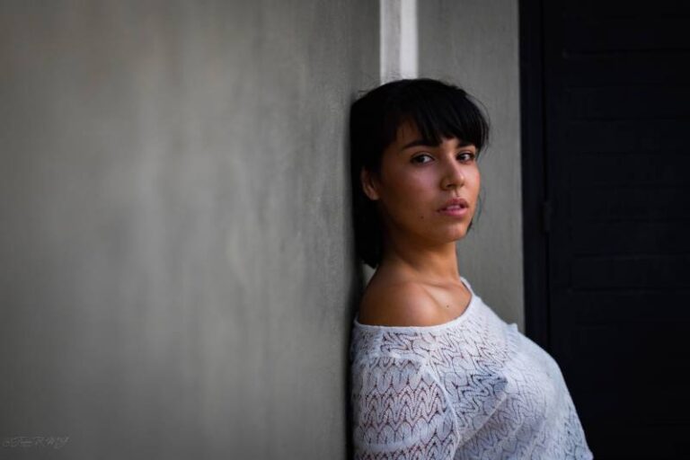 thoughtful woman leaning on wall