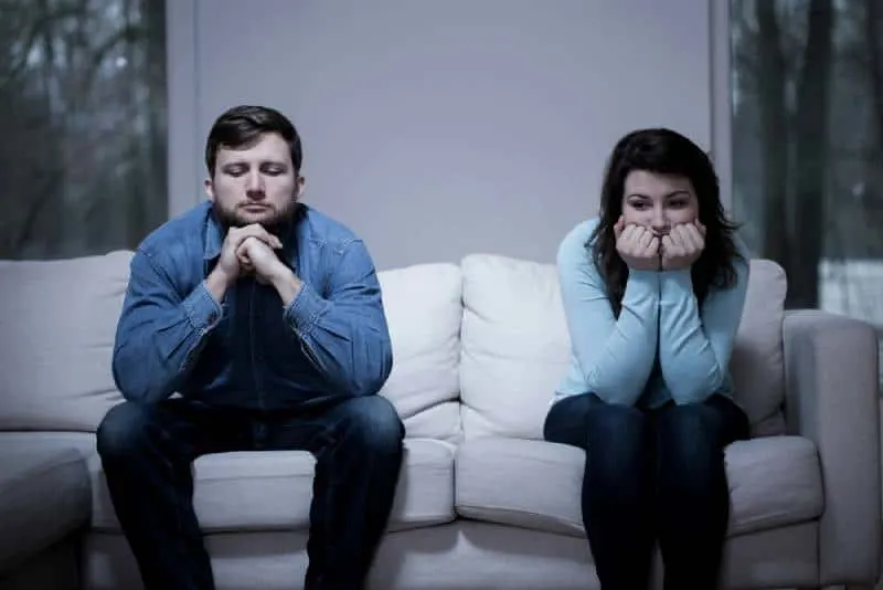 Couple sitting on sofa after argument