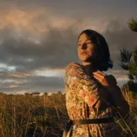woman with confident look at sunrise