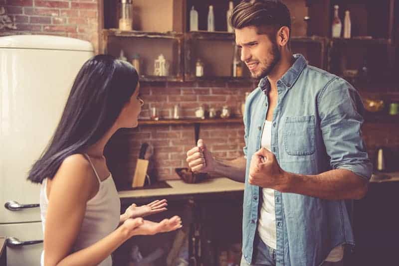 angry man talking with his upset girlfriend