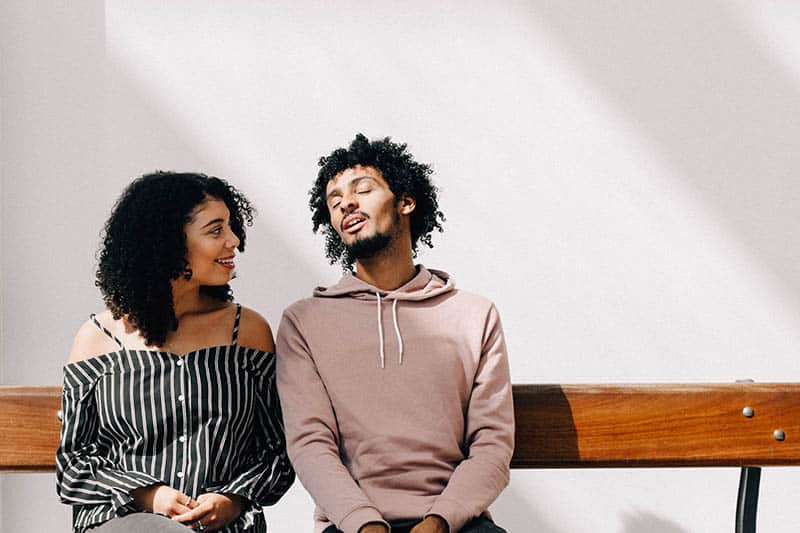 couple sitting at park bench